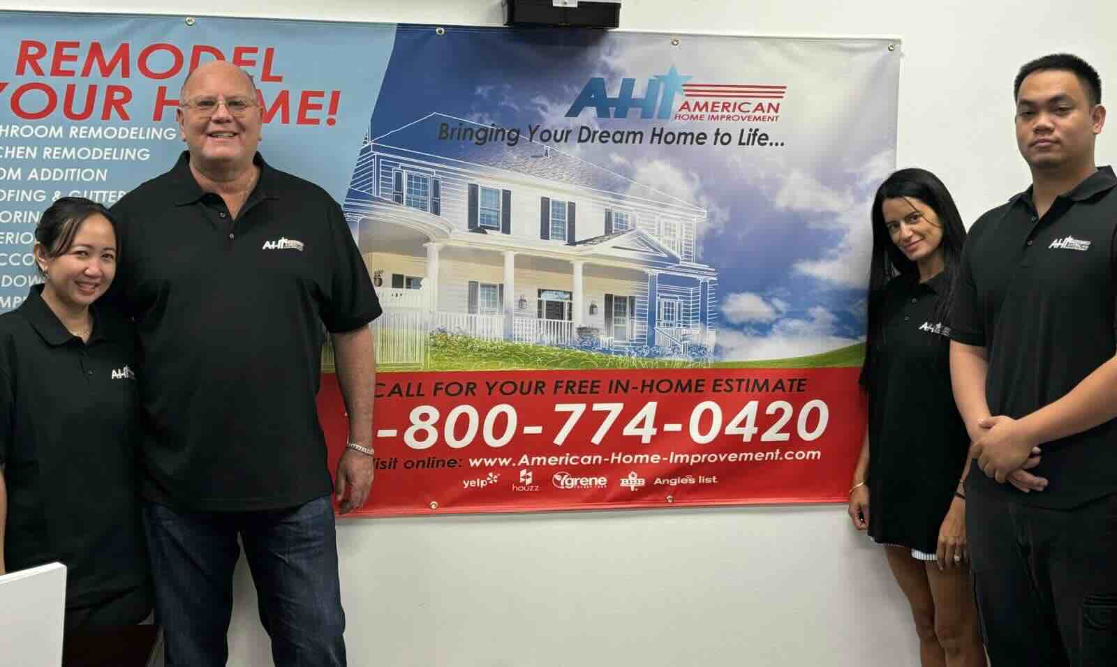 Photo of the American Home Improvement Inc. team standing around their poster