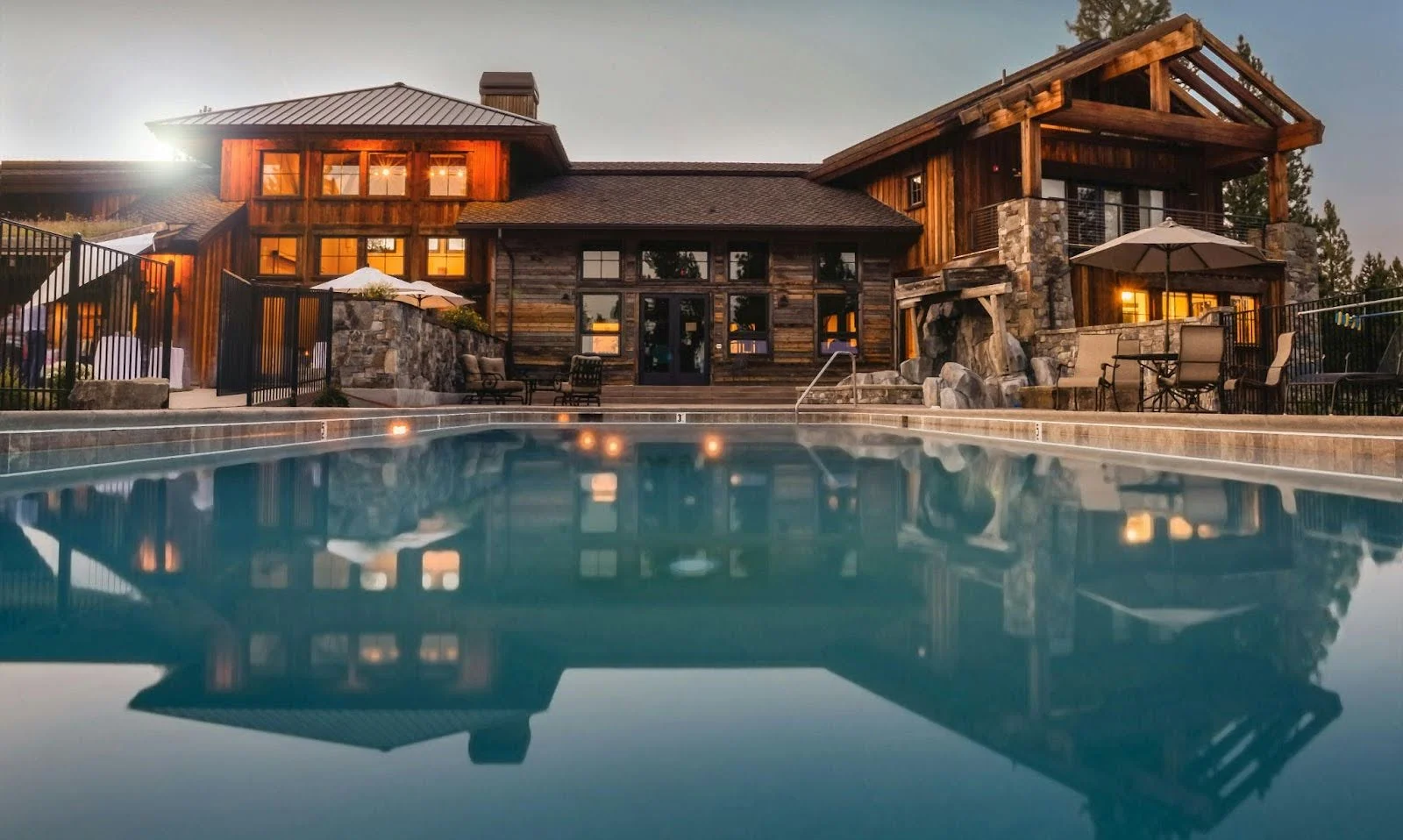 picture-of-a-large-rustic-wood-and-stone-lodge-glowing-with-warm-interior-lights